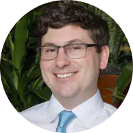 Friendly doctor at TMJ & Sleep Therapy Centre of North Texas smiling in office.